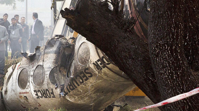 Investigators look at the remains of a small BSF plane that crashed outside the airport in New Delhi (Photo: PTI) Investigators look at the remains of a small BSF plane that crashed outside the airport in New Delhi (Photo: PTI)